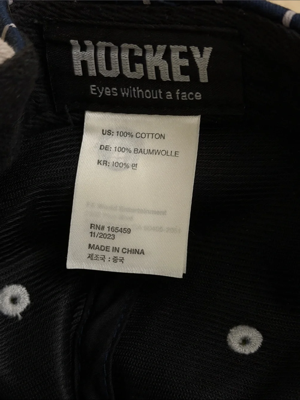 Hockey eyes without a face white and navy striped hat